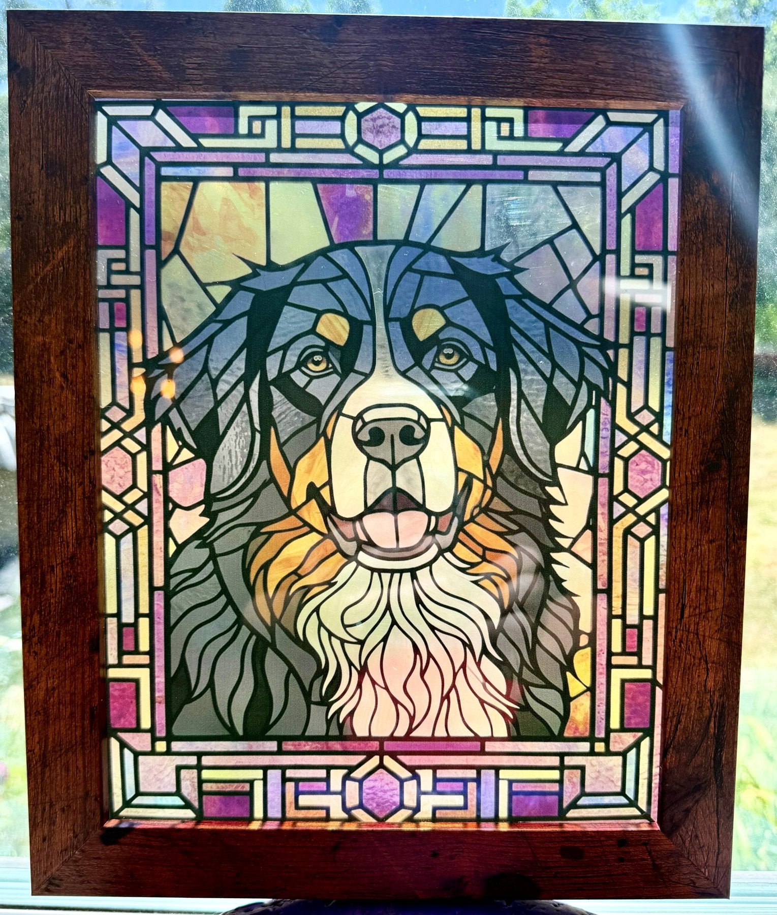Framed Bernese Mountain Dog stained-glass acrylic panel displayed in a window